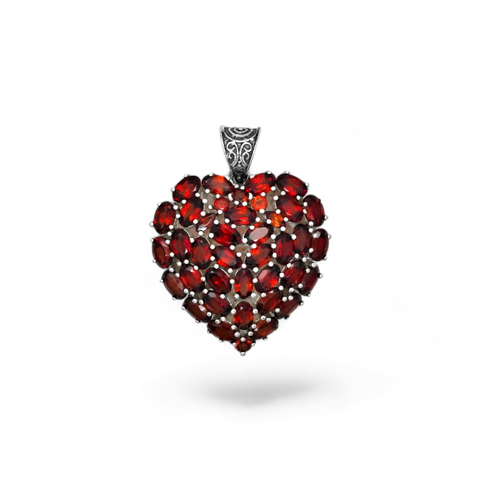 Heart-shaped gemstone pendant with silver frame on a white background