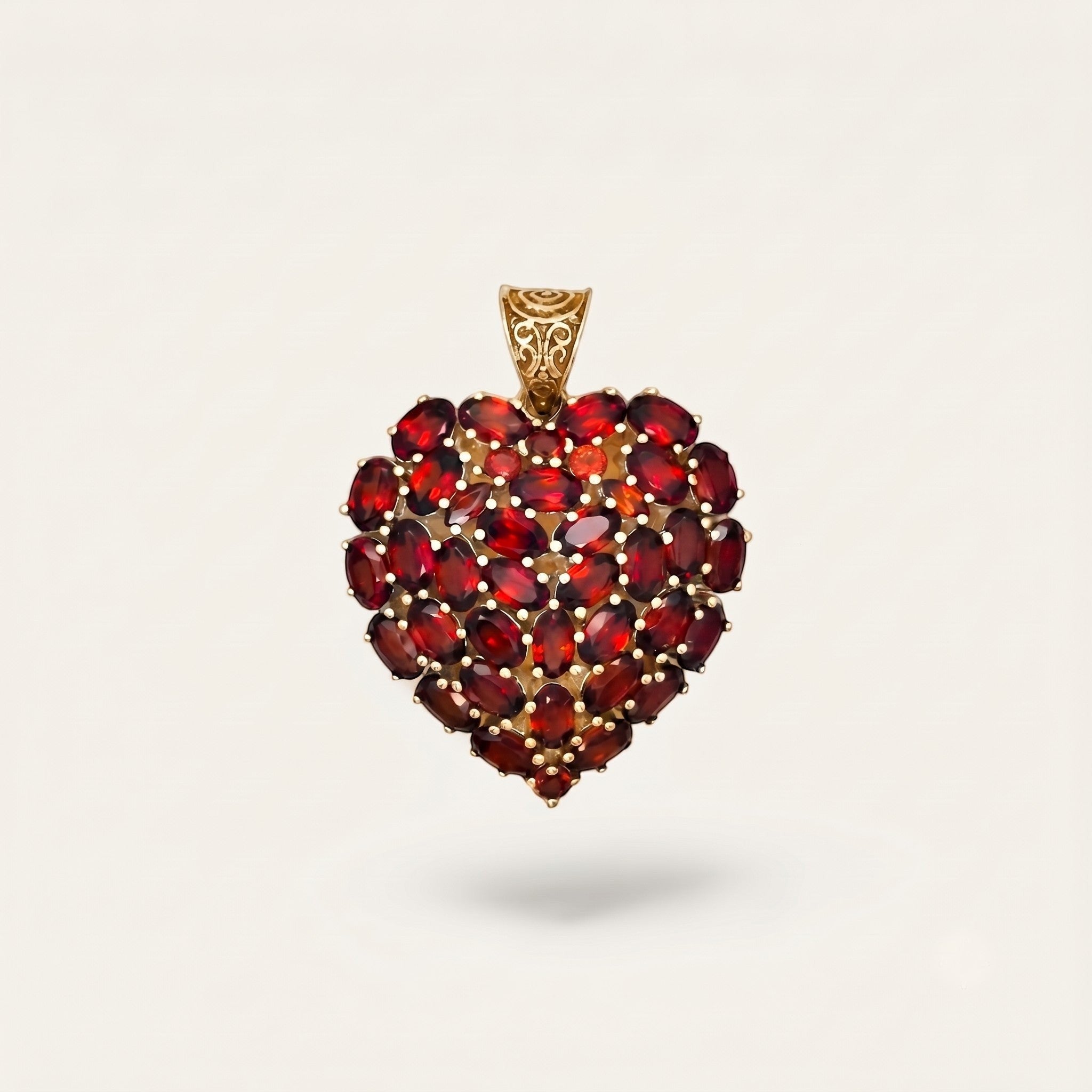 ZIVORI heart pendant featuring a cluster of oval-cut red garnet gemstones set in 925 sterling silver with filigree bail