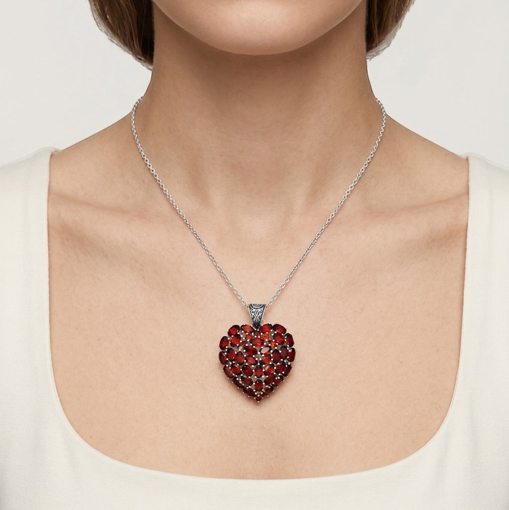 ZIVORI garnet cluster heart pendant in 925 sterling silver with a filigree bail worn on a silver chain.