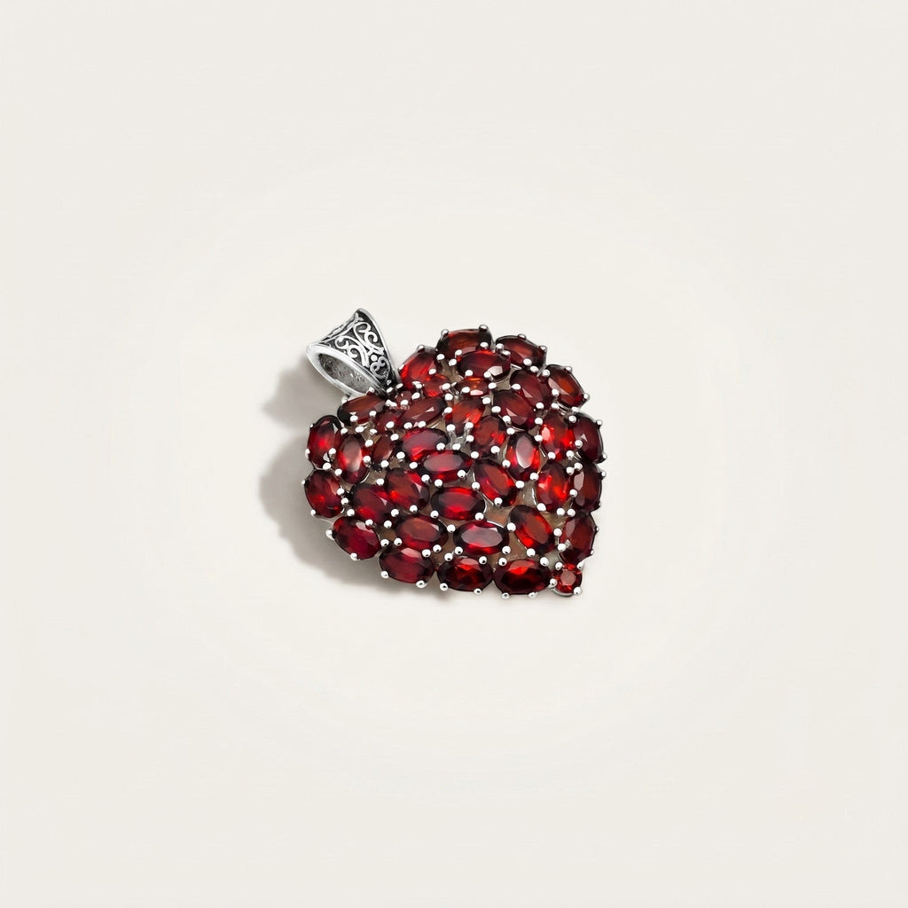 ZIVORI heart pendant featuring a cluster of oval-cut red garnet gemstones set in 925 sterling silver with filigree.