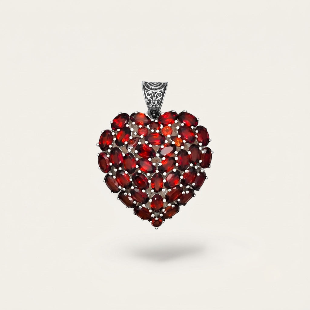 ZIVORI heart pendant featuring a cluster of oval-cut red garnet gemstones set in 925 sterling silver with filigree bail