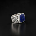 ZIVORI sterling silver signet ring with a deep blue lapis lazuli stone and intricate wing side detailing.