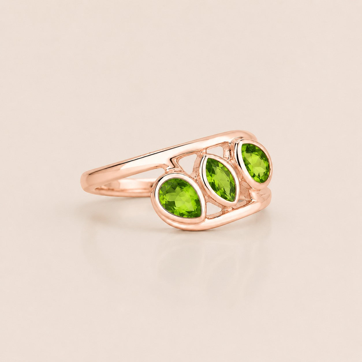 ZIVORI Verdant Trilogy ring featuring three pear-cut natural peridot stones set in sculptural rose-tone sterling silver.