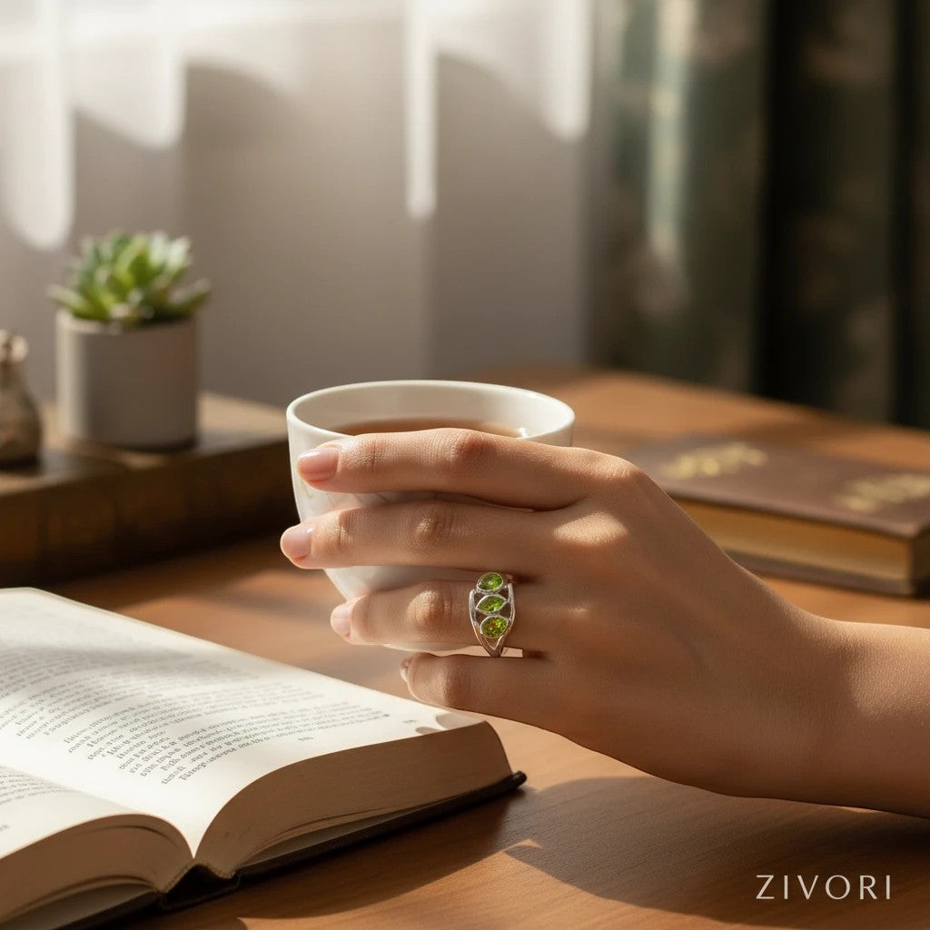 ZIVORI Verdant Trilogy ring featuring three natural peridot stones set in sculptural 925 sterling silver on a hand.