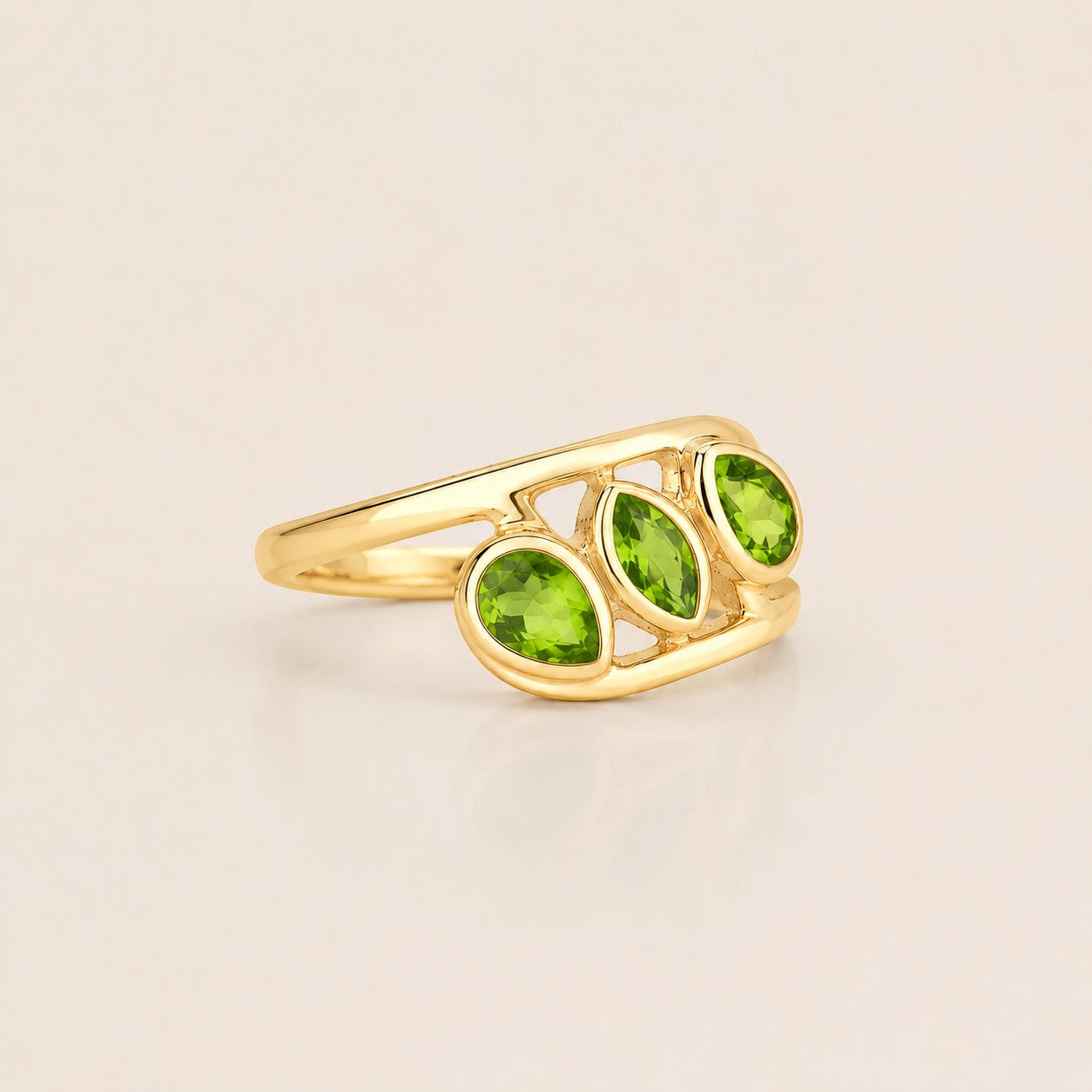 ZIVORI Verdant Trilogy ring featuring three natural green peridot stones set in a sculptural gold-tone band.