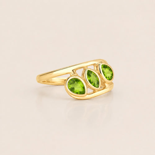 ZIVORI Verdant Trilogy ring featuring three natural green peridot stones set in a sculptural gold-tone band.