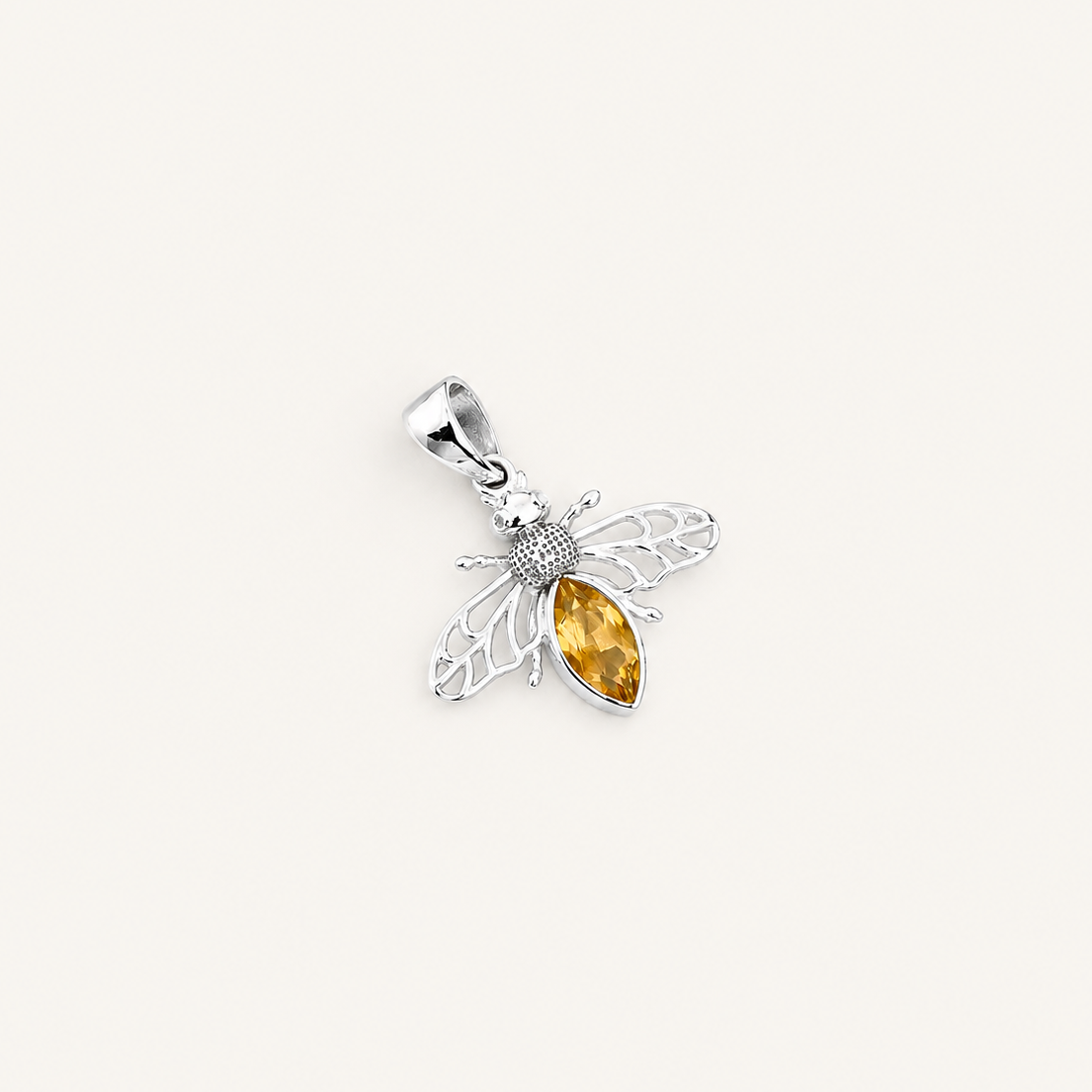 Silver pendant with a yellow gemstone on a white background